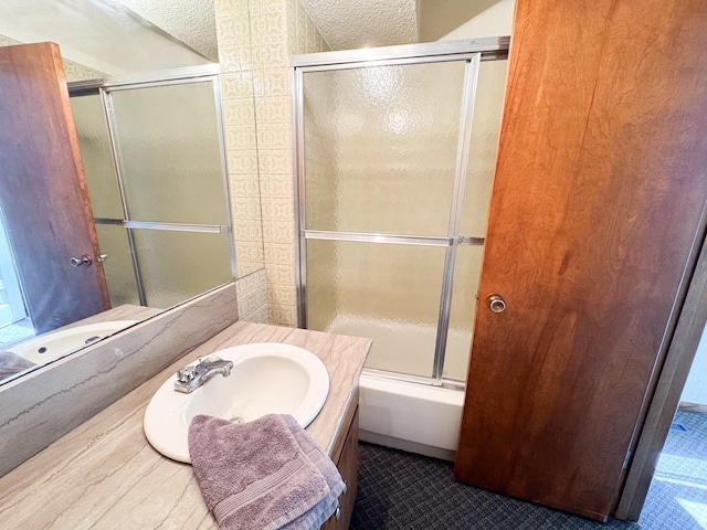bathroom with vanity and combined bath / shower with glass door