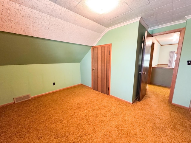 bonus room featuring carpet, baseboards, and lofted ceiling