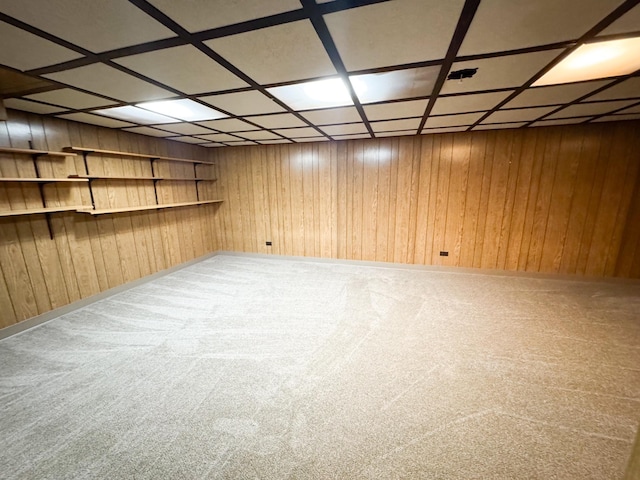 finished basement featuring carpet floors and wood walls