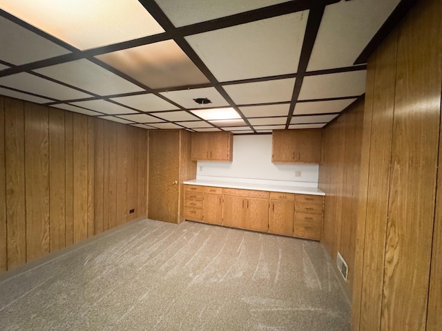 finished below grade area with wood walls and light carpet