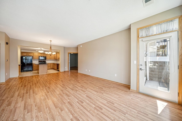 620 Wesley Commons Dr Unit 22, Golden Valley, MN 55427 - unfurnished living room with light wood-style flooring, a chandelier, and baseboards