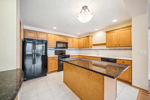620 Wesley Commons Dr Unit 22, Golden Valley, MN 55427 - kitchen with black appliances, a sink, dark stone countertops, a center island, and light tile patterned flooring