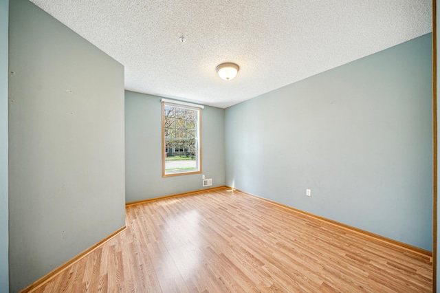 620 Wesley Commons Dr Unit 22, Golden Valley, MN 55427 - spare room featuring a textured ceiling, wood finished floors, and baseboards