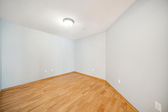 620 Wesley Commons Dr Unit 22, Golden Valley, MN 55427 - spare room with wood finished floors, baseboards, and a textured ceiling