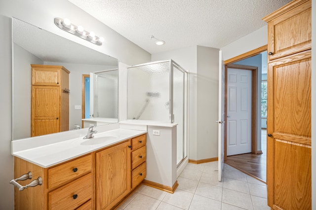 620 Wesley Commons Dr Unit 22, Golden Valley, MN 55427 - bathroom with a stall shower, tile patterned floors, vanity, and a textured ceiling