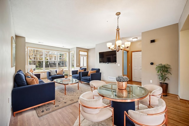 620 Wesley Commons Dr Unit 22, Golden Valley, MN 55427 - living room with light wood-type flooring, a chandelier, and baseboards