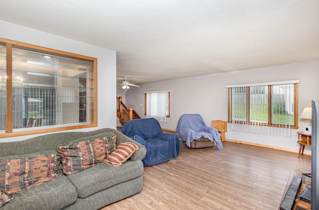 5870 Lynwood Blvd, Mound, MN 55364 - living room with wood finished floors, stairway, a textured ceiling, and ceiling fan