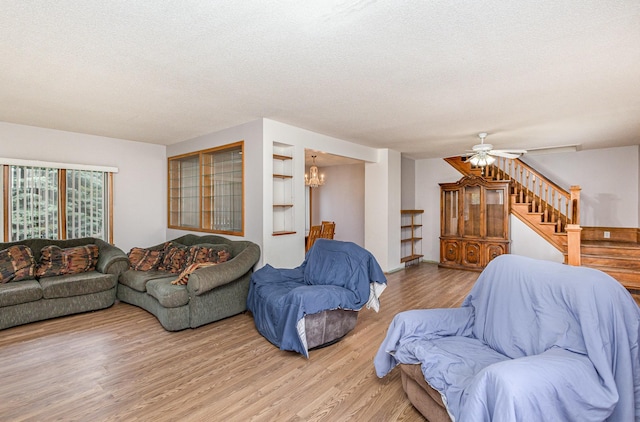 5870 Lynwood Blvd, Mound, MN 55364 - living area with light wood-style flooring, a textured ceiling, a chandelier, stairway, and ceiling fan