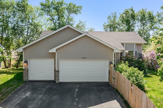 426 Dillon Ave N, Montrose, MN 55363 - garage featuring driveway and fence