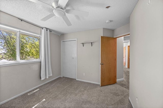 426 Dillon Ave N, Montrose, MN 55363 - unfurnished bedroom with a textured ceiling, carpet floors, a ceiling fan, baseboards, and a closet