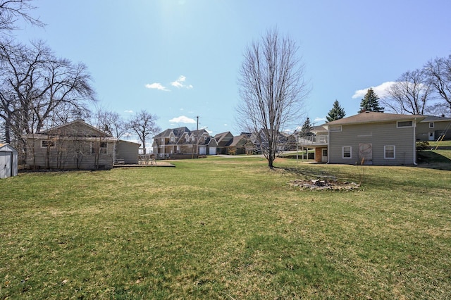 4528 Aberdeen Rd, Mound, MN 55364 - view of yard with an outdoor structure, a wooden deck, a storage unit, and a residential view
