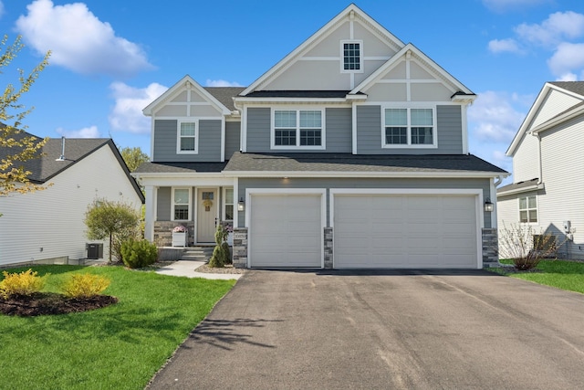 10859 23rd St NE, Saint Michael, MN 55376 - craftsman-style house featuring stone siding, asphalt driveway, an attached garage, a front yard, and a shingled roof