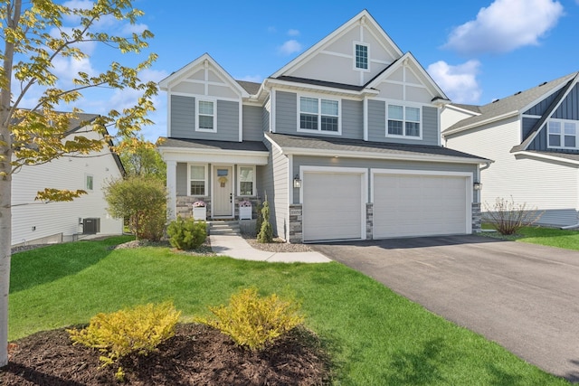 10859 23rd St NE, Saint Michael, MN 55376 - view of front facade with stone siding, asphalt driveway, a garage, a front yard, and central AC unit