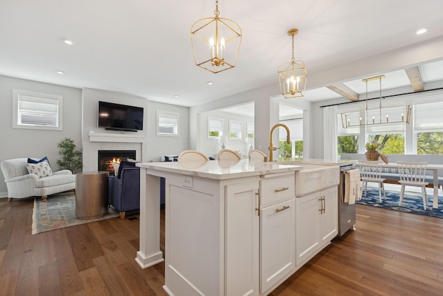 10859 23rd St NE, Saint Michael, MN 55376 - kitchen with open floor plan, stainless steel dishwasher, a tiled fireplace, dark wood-style flooring, and decorative light fixtures