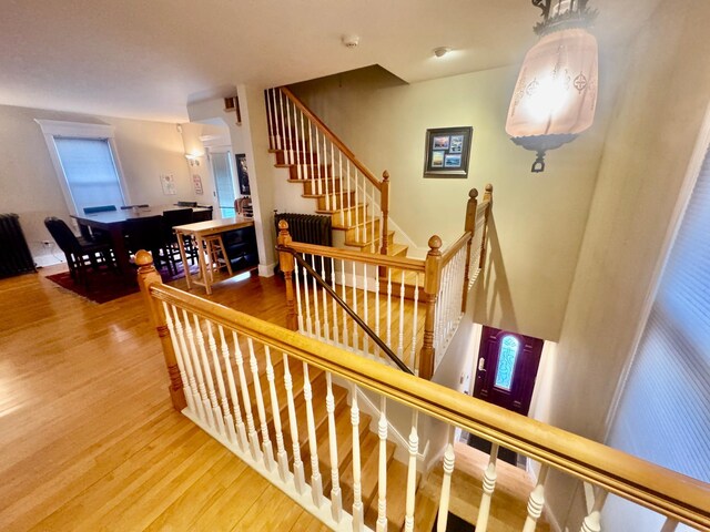 staircase featuring radiator and wood finished floors