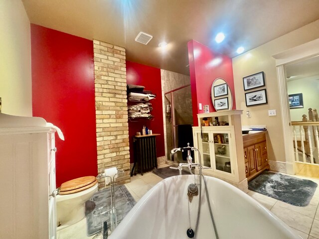 full bath with tile patterned flooring, a shower with door, toilet, radiator heating unit, and a soaking tub