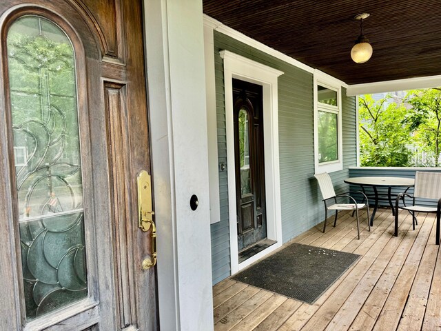 view of exterior entry featuring covered porch