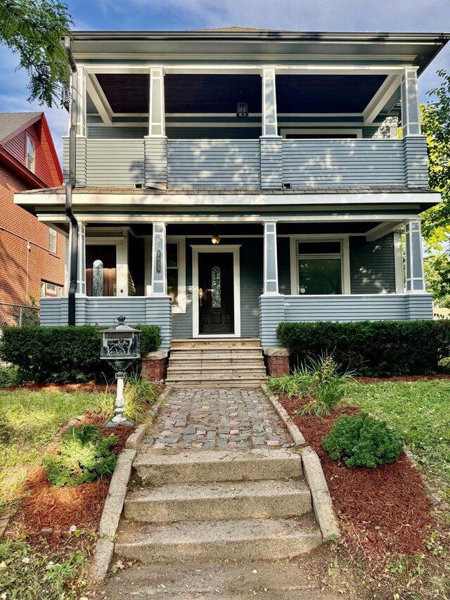 view of front of house featuring a porch and a balcony