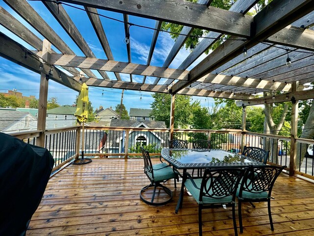 deck with outdoor dining area, grilling area, and a pergola