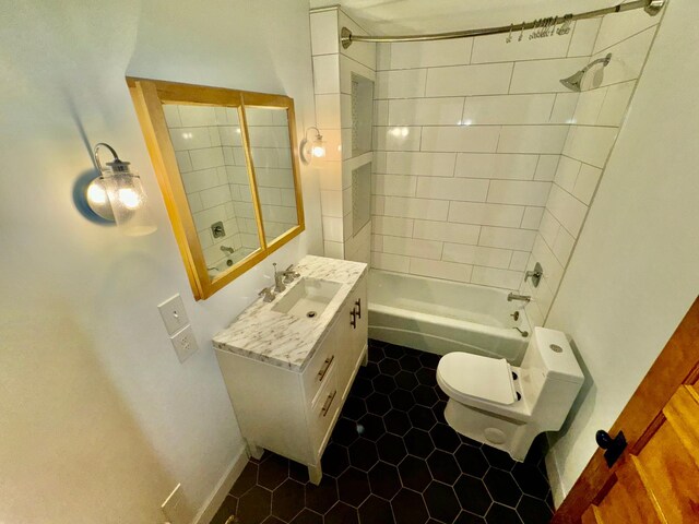bathroom with toilet, tile patterned floors, shower / bathing tub combination, and vanity