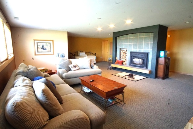 living room with carpet floors, recessed lighting, and a tile fireplace