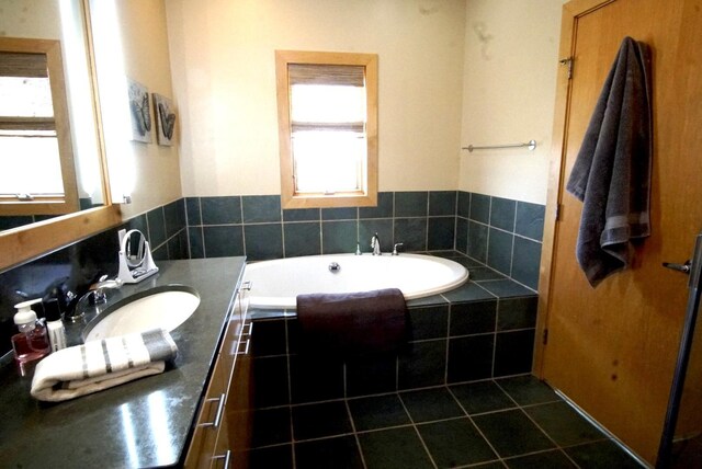 full bath with vanity and a garden tub