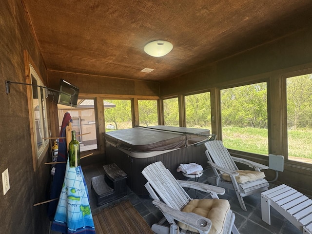 sunroom / solarium with a hot tub