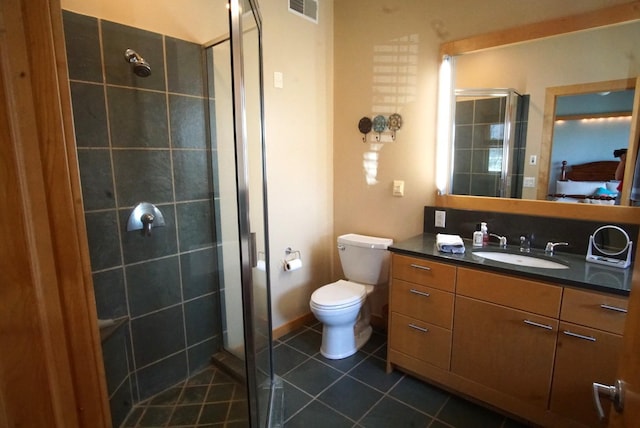 bathroom featuring a stall shower, tile patterned floors, vanity, and toilet