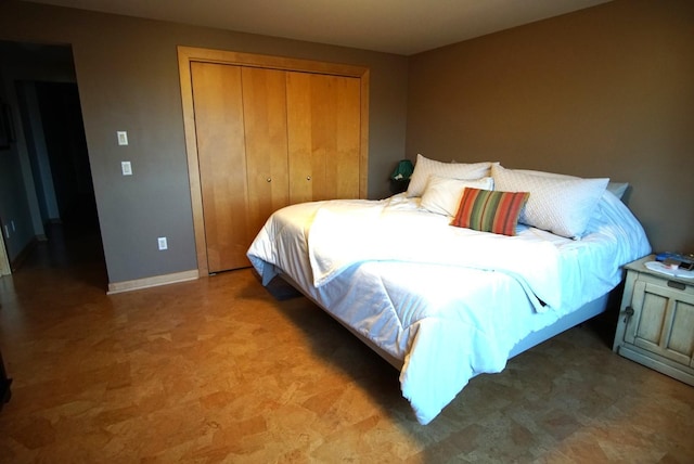 bedroom featuring a closet and baseboards