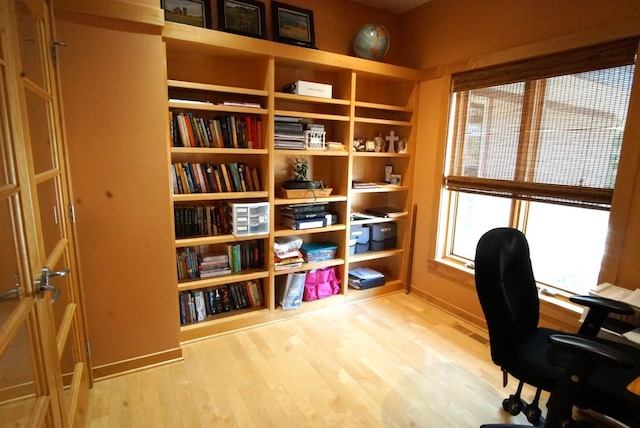 home office with wood finished floors and baseboards