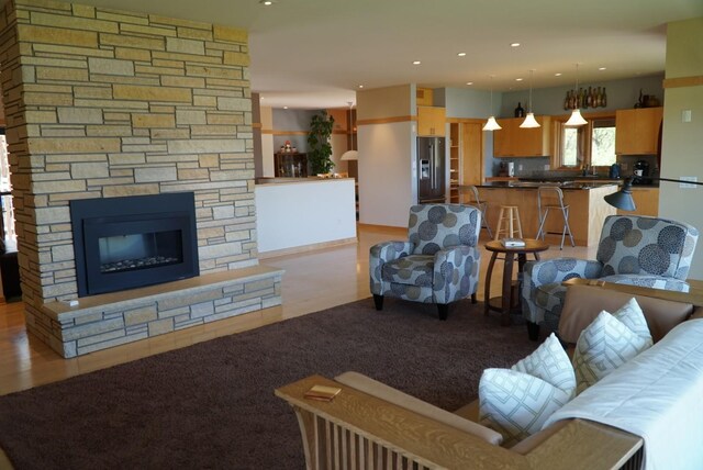 living room featuring recessed lighting and a fireplace