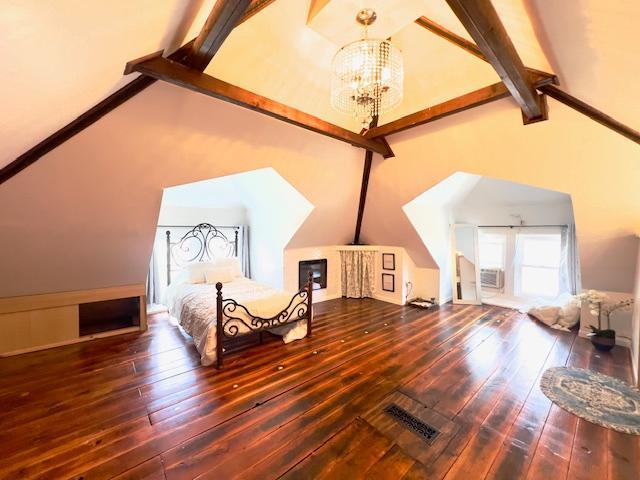 bedroom with visible vents, high vaulted ceiling, beamed ceiling, wood-type flooring, and an inviting chandelier