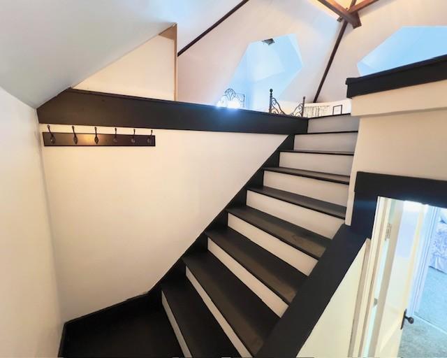 stairs with lofted ceiling