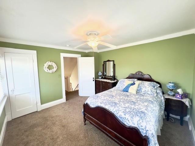 carpeted bedroom with crown molding, baseboards, and ceiling fan