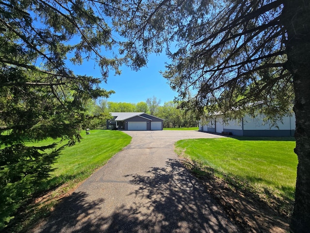 11170 207th Ave NW, Elk River, MN 55330 - view of front of home featuring driveway, a front lawn, and an attached garage