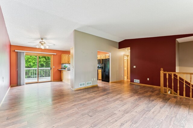 11170 207th Ave NW, Elk River, MN 55330 - unfurnished living room featuring light wood-style floors and a ceiling fan