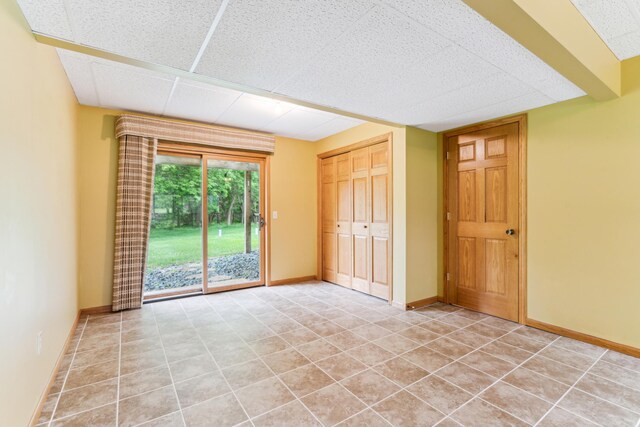 11170 207th Ave NW, Elk River, MN 55330 - unfurnished bedroom with access to exterior, light tile patterned floors, and a closet