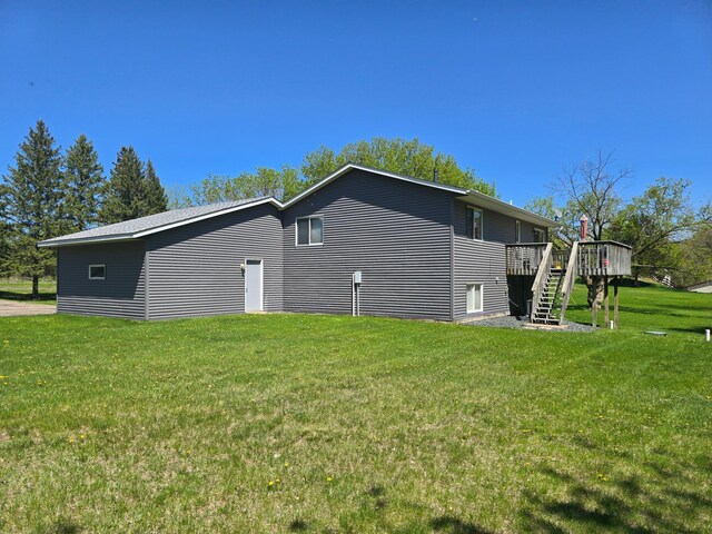 11170 207th Ave NW, Elk River, MN 55330 - view of property exterior featuring stairs, a wooden deck, and a lawn