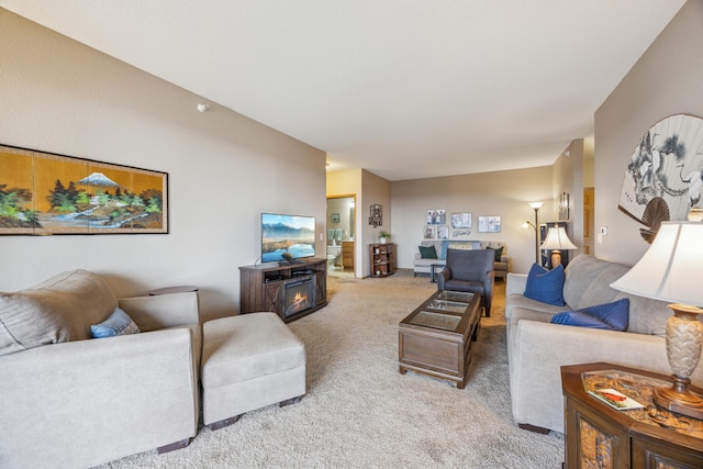 carpeted living area with a fireplace