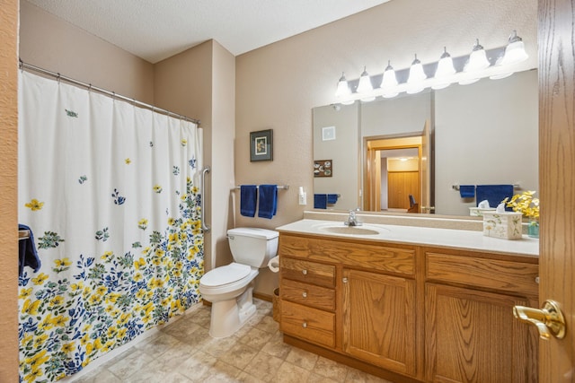 bathroom with toilet, curtained shower, vanity, and tile patterned flooring