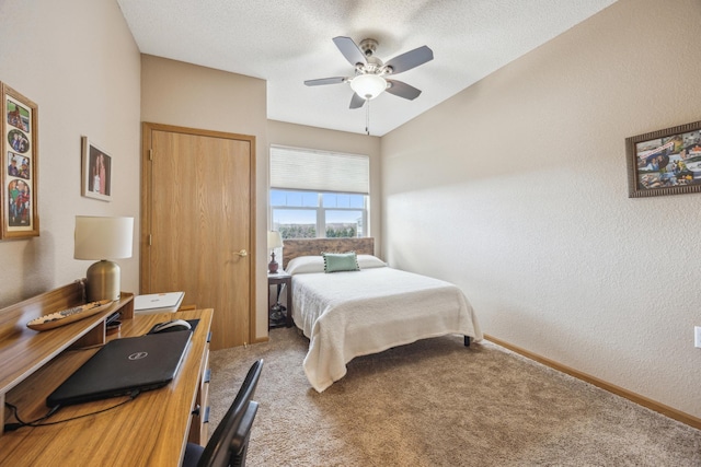 carpeted bedroom featuring a textured ceiling, a textured wall, a ceiling fan, and baseboards