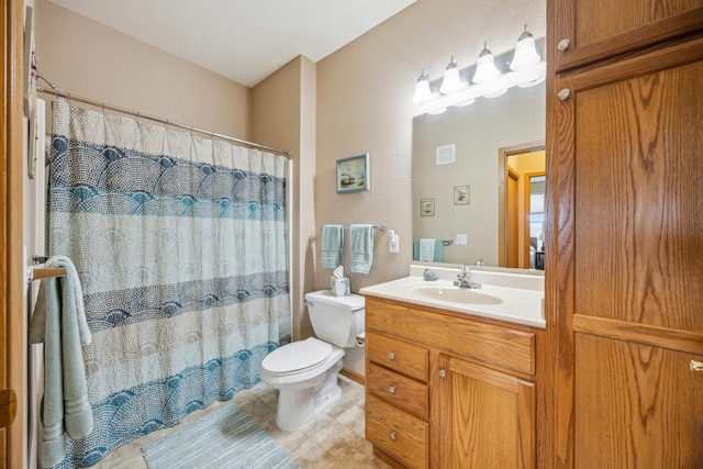 bathroom with vanity, toilet, and curtained shower