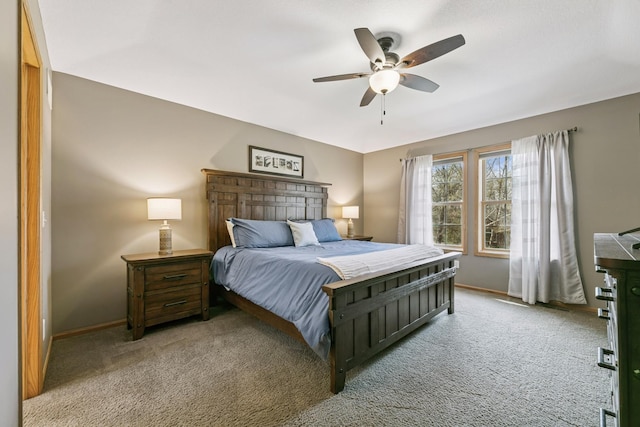 bedroom with baseboards, a ceiling fan, and light carpet