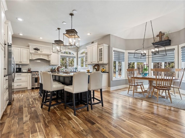 dining area with recessed lighting, an inviting chandelier, baseboards, and dark wood-type flooring
