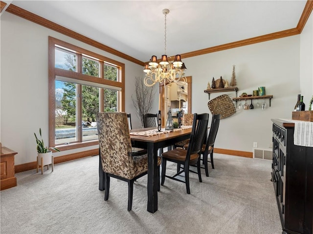 dining room featuring baseboards, ornamental molding, light carpet, and an inviting chandelier