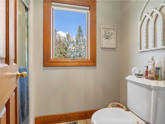 bathroom featuring toilet and baseboards