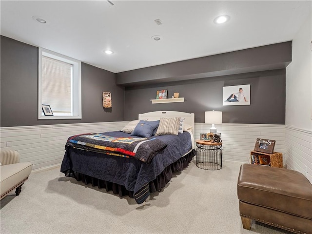 bedroom with recessed lighting, wainscoting, and carpet