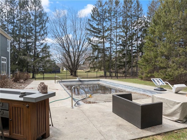 view of swimming pool with a patio, a fenced in pool, and a fenced backyard