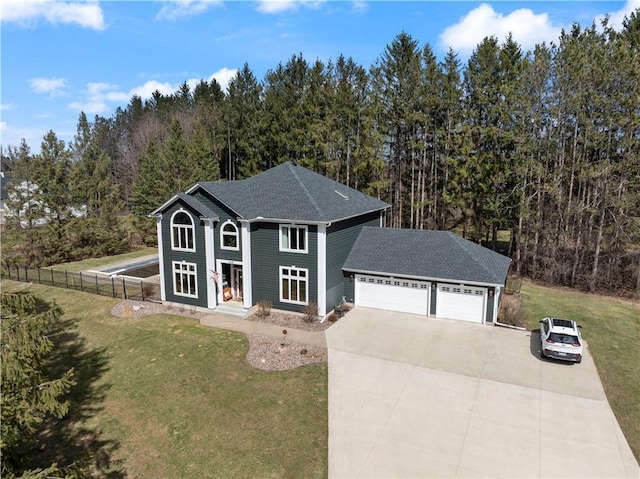 view of front of house featuring a front lawn, a shingled roof, driveway, an attached garage, and fence