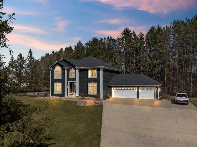 view of front of house with driveway, fence, a lawn, and an attached garage